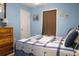 Comfortable bedroom features a blue painted walls, a traditional dresser, and a charming sailboat themed quilt at 16 Baldwin Ln, Green Pond, SC 29446