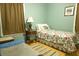 Cozy bedroom with a floral-patterned single bed, window, side table, and dog bed at 16 Baldwin Ln, Green Pond, SC 29446