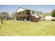 Charming raised home with spacious screened porch, outdoor staircase, and expansive green lawn at 16 Baldwin Ln, Green Pond, SC 29446