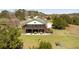 Exterior elevation of a stilted house with a spacious screened porch and well-maintained lawn at 16 Baldwin Ln, Green Pond, SC 29446