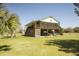 Spacious stilted home exterior with screened porch, large yard, and mature landscaping at 16 Baldwin Ln, Green Pond, SC 29446