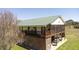 Exterior of a stilted home featuring a screened porch, well-manicured lawn, and ample space at 16 Baldwin Ln, Green Pond, SC 29446