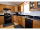 Traditional kitchen features wooden cabinets, black countertops, and modern appliances at 16 Baldwin Ln, Green Pond, SC 29446