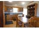 Spacious kitchen with wood cabinets, a dining table, and ample natural light at 16 Baldwin Ln, Green Pond, SC 29446