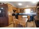 Traditional kitchen with wood cabinetry, black appliances, and a breakfast table at 16 Baldwin Ln, Green Pond, SC 29446