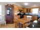 Traditional kitchen with wood cabinetry, black appliances, and dining area at 16 Baldwin Ln, Green Pond, SC 29446