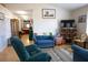Bright living room with wood floors, comfortable blue seating, and natural light at 16 Baldwin Ln, Green Pond, SC 29446