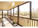 Cozy screened-in porch offers serene views, comfortable seating, and natural light at 16 Baldwin Ln, Green Pond, SC 29446