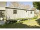 Durable metal shed with a single door and two windows, surrounded by potted plants and green grass at 16 Baldwin Ln, Green Pond, SC 29446