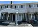 A two-story townhome featuring gray siding, black shutters, and a covered front porch at 1713 Boone Hall Dr # I9, Charleston, SC 29407