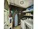 Compact laundry room featuring a washer, dryer, and a water heater at 1713 Boone Hall Dr # I9, Charleston, SC 29407