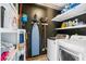 Efficient laundry room featuring modern appliances, shelving, and a water heater at 1713 Boone Hall Dr # I9, Charleston, SC 29407