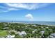 Beautiful aerial view of a coastal community with lush trees and ocean views under a blue sky at 1714 Middle St, Sullivans Island, SC 29482