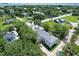 Expansive aerial view of lush community with tree-lined streets surrounding elegant home at 1714 Middle St, Sullivans Island, SC 29482