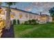 Large backyard with flourishing landscaping, healthy green lawn, and beautiful views of the sunset sky at 1714 Middle St, Sullivans Island, SC 29482