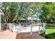 A beautiful outdoor firepit with seating area on a large lot with mature trees at 1714 Middle St, Sullivans Island, SC 29482