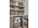Elegant bar area with wooden shelves, wine cooler, marble countertop, and decorative backsplash at 1714 Middle St, Sullivans Island, SC 29482