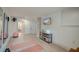 Open-concept basement with exercise area, TV, exposed brick, and doorway into a bathroom at 1714 Middle St, Sullivans Island, SC 29482