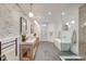 Elegant bathroom with brick accent wall, double vanity, soaking tub, and glass-enclosed shower at 1714 Middle St, Sullivans Island, SC 29482