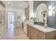 Bright bathroom featuring a long vanity with double sinks and stylish fixtures plus light wood flooring at 1714 Middle St, Sullivans Island, SC 29482