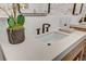 Bright bathroom features a modern sink with black fixtures, lovely floral decor, and a unique brick accent wall at 1714 Middle St, Sullivans Island, SC 29482