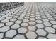 Detailed view of hexagon tile bathroom flooring, with gray and white honeycomb pattern and dark trim at 1714 Middle St, Sullivans Island, SC 29482