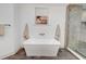 Bathroom features a standalone tub next to a glass enclosed shower, with a surfboard art piece on the wall at 1714 Middle St, Sullivans Island, SC 29482