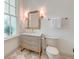 Classic bathroom with a vanity, framed mirror, sconces, and a coordinating toilet at 1714 Middle St, Sullivans Island, SC 29482