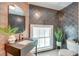 Modern bathroom with black tiled walls, a sleek vanity, and a large window for natural light at 1714 Middle St, Sullivans Island, SC 29482