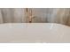 Close up of a freestanding white bathtub with a gold-toned faucet and light marble tile surround at 1714 Middle St, Sullivans Island, SC 29482