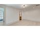 Minimalist bedroom with light wood floors and white walls leading into a bathroom at 1714 Middle St, Sullivans Island, SC 29482