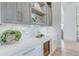 Butler's pantry with marble countertops, wine fridge, and custom cabinets at 1714 Middle St, Sullivans Island, SC 29482
