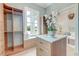 Organized walk-in closet featuring custom built-ins, a window seat, and natural light at 1714 Middle St, Sullivans Island, SC 29482