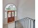Bright entryway features elegant double doors with decorative glass above and stylish staircase railing at 1714 Middle St, Sullivans Island, SC 29482