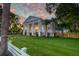 Elegant home with a manicured lawn and mature trees at 1714 Middle St, Sullivans Island, SC 29482