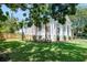 Charming home with white siding, inviting porch, and beautiful landscaping with mature trees at 1714 Middle St, Sullivans Island, SC 29482