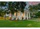 A large Southern-style home surrounded by mature trees and an expansive green lawn at 1714 Middle St, Sullivans Island, SC 29482
