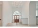 Bright foyer with wood floors, arched windows above the entry door, and modern chandelier at 1714 Middle St, Sullivans Island, SC 29482