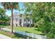 Grand exterior featuring a white picket fence, manicured lawn, and a stately home with columns at 1714 Middle St, Sullivans Island, SC 29482
