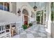Inviting front porch with rocking chairs, a tiled floor, and charming architectural details at 1714 Middle St, Sullivans Island, SC 29482