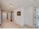 Hallway with light wood floors, brick accent wall, barn doors, and natural light at 1714 Middle St, Sullivans Island, SC 29482