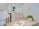 Bright hallway with a wooden desk, neutral walls, and modern railing, offering a clean aesthetic at 1714 Middle St, Sullivans Island, SC 29482