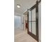 Bright hallway featuring a modern black sliding barn door with glass panes and light hardwood flooring at 1714 Middle St, Sullivans Island, SC 29482