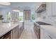 Kitchen with stainless steel appliances, marble backsplash, and large island at 1714 Middle St, Sullivans Island, SC 29482