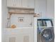 Well-lit laundry room with mosaic tiles, utility sink, and modern washer at 1714 Middle St, Sullivans Island, SC 29482