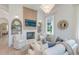 Comfortable living room with a fireplace, built-in shelving, and stylish decor bathed in natural light at 1714 Middle St, Sullivans Island, SC 29482