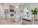 Bright living room with fireplace, wood floors, chandelier, and dining area at 1714 Middle St, Sullivans Island, SC 29482