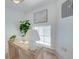 Clean office space features a modern desk with a white lamp, cozy plants, and natural lighting at 1714 Middle St, Sullivans Island, SC 29482