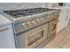 Close up of a stainless steel, double oven gas range with brass accents against a white marble backsplash at 1714 Middle St, Sullivans Island, SC 29482