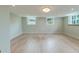 Bright, empty room with light-colored walls, hardwood floors, recessed lighting, and double windows at 1714 Middle St, Sullivans Island, SC 29482